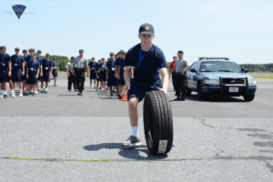Kevin Freud participates in a timed shuttle run with tire. 
