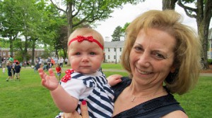 All decked out in stars, stripes and polka dots, 7-month-old Gabrielle Gamache watches the parade with her grandmother Janet Dee Mulcahy.
