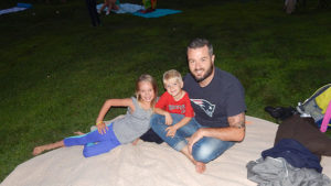 Dale Kline with his children Vanessa, 7, and Beckham, 4, anxiously await the start of the film. Photos Melanie Petrucci