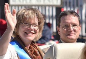 Martha Gach and her husband, Gerard, ride in a 1971 Pontiac LeMans convertible as she’s honored as the parade grand marshal.