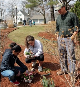 (l to r) Shalini Nehra, 17, and Danielle Noack, 17 plant flowers to beautify the Shrewsbury Towers as State Rep. Matthew Beaton, R-Shrewsbury, looks on.   Photo/Rebecca Kensil  