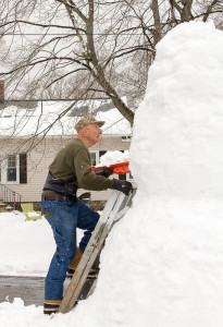 Ken Swift works on his 11-foot snowman. 