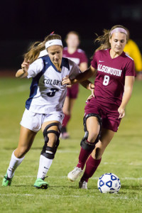 Algonquin’s Kate Hostage (#8) holds off Shrewsbury’s Bridget Campos (#3) as she brings the ball upfield.