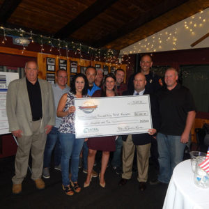 Shrewsbury Selectman Beth Casavant, State Rep. Hannah Kane, Shrewsbury Fire Captain Sean Lawlor (l to r, holding check) with members of the Shrewsbury Fire and Police Relief Association. Photo/submitted