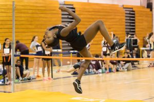 A Marlborough competitor looks toward her landing as she clears the high jump. 