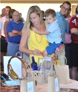 Katie DiPierro and Thomas, 3, check out the items of the brown bag raffle.
