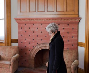 A pensive Ellen Dolan, Shrewsbury Public Library director, reflects in the front area of the original library wing.  The chairs in the background are part of the sale. 