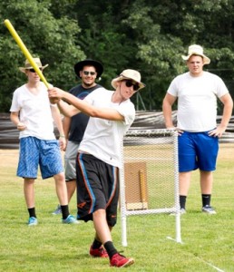In the adult division of the tournament, team members of The Goats cheer on Nate as he goes up to bat. 