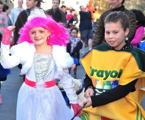 Erin Navaroli, 9, dressed as a pink princess, walks with Jessica Wills, 10, as a box of crayons. 