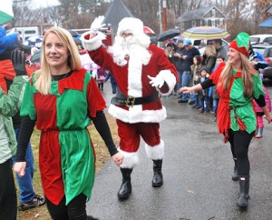 Santa is escorted to the Community House by elves (l to r) Dayna Buckley and Julia Spencer, event chair.