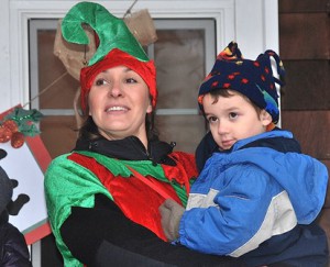 Jocelyn Gregory and her son Lucas Hash, 4, watch Santa approach the Community House. 