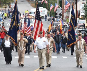 Commander Steve Whynot of VFW Post 3276 (front) leads a color guard of local veterans.
