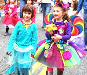 Six-year-old friends walking together are Eva Lesniewski, dressed as a mermaid, and Lyla Spencer, as a candy fairy. 