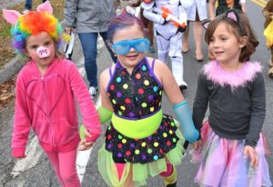 Walking together are 5-year-old friends (l to r) Claire McDougall costumed as a piglet, Scarlett Spencer as a rock star, and Lucy Lesniewski as a cat. Photos/Ed Karvoski Jr.