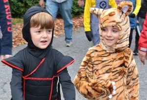Carson Miller, 6, walks in the parade as a ninja with Jax McDowell, 7, as a tiger.