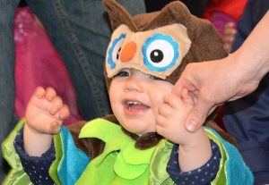 Dressed as an owl, Ace McDowell, 1, waves to the costume contest judges.