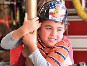 Steven Murphy, 6, gets to climb the pole at the Southborough Fire Department open house.