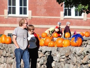Guests check the carved and decorated pumpkins displayed on Common Street.