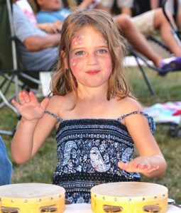 Loreli Rose, 4, plays percussion instruments at a table sponsored by the New England Music Academy in Westborough and West Boylston.