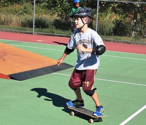 Fourth-grader Jack Battles skateboards around the park.