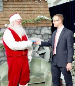 Santa receives his E-Z pass personally from a MassDOT official. 