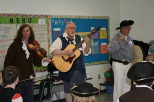 The Jolly Rogues perform for the students.