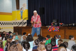 T-Bone (Tom Stankus) delights the students at the Kane School with his stories and singing.