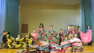 Zeh School students showcase their blanket creations.