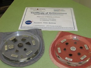 Close-up of the lunar rock and soil sample discs along with Kristen MacDonald’s certification