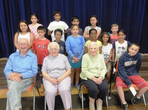(front, l to r) - Lowell Crouse, Lucy Hastings Ward, Christine Mattero Betti and her great-grandson Dominic Betti, pose for a photo with Calvin Coolidge Elementary School fourth grade students.  Photo/Mary Pritchard 