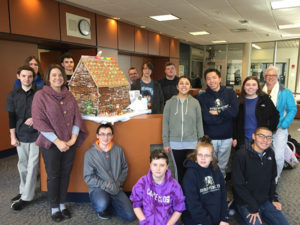 Cathy LaRoche (second from left) with members of the Shrewsbury High School M.O.V.E. program gather around Gingerbread House they created earlier this month. Photo/Melanie Petrucci 