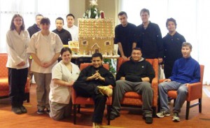 The MOVE students pose with the gingerbread house they created as part of a collaboration with the Courtyard by Marriott in Marlborough.   Photo/submitted  