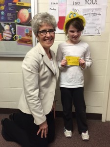 Shrewsbury Library Director Ellen Dolan with raffle prize winner, second-grader Alexis.