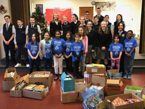 Students from St. Mary and Columbus Park schools with books collected for students. Photo/submitted