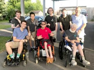 Students participated in a wheelchair race at L'Arche Community in Syracuse: (front) student Ronan O'Hara, L'Arche Community residents Brad and Mary; (back) students Ryan McDonnell, Declan Murphy, Donald 'DJ' Ormond and Luc Grenier, and history teacher Nick Argento. Photo/submitted