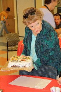 Maureen Sargent of the Friends of the Northborough Senior Center shows off the fall themed cake donated by Dorothy Magoun for the September birthday luncheon.