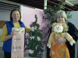 ADVISE co-chairs Janet Trippi (left) and Joanne Tyndall, show off some of the donations that have come in for the organization's upcoming tag sale being held to benefit victims of domestic violence. (Photo/Lori Berkey)