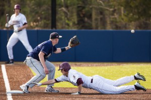 Algonquin’s Andrew Tache dives back to first base as Shrewsbury’s Ryan Pumphret prepares to catch the throw