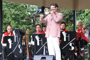 Dan Gabel (standing) performs with members of the High Society Orchestra.