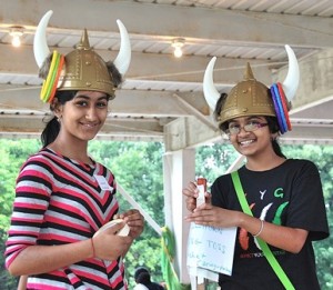 Mansi Gera and Divya Raghunathan, both 11, volunteer to help with the bullhorn ring toss game.