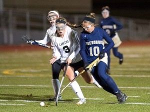 Shrewsbury High School's Justine Sheehan (#10, right) races Longmeadow High School's Jessie Moriarty (#3, left) to the ball.