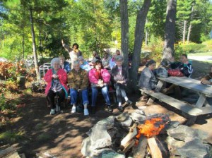 Participants in the New England Dream Center enjoy a campfire sing-a-long.