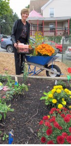 Nancy Thibault of Shrewsbury helps get the new garden at the Rainbow Child Development Center ready for the ribbon-cutting ceremony.