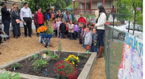 Preschool children and their teachers get ready to cut the yellow ribbon to open the new garden at the Rainbow Child Development Center. (Photos/Joyce DeWallace)