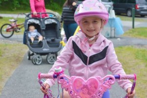 Rebecca, 8, is all smiles as she rides her princess-themed bike.