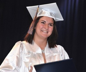Natalie Caccialino happily receives her diploma. 