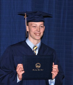 Brandon Bourette displays his diploma.