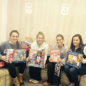 Volunteers hold donated toys to be distributed to needy children. Photo/submitted