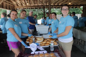 Volunteer members serve the barbecue meal. 