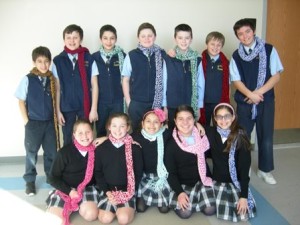 Last year’s fifth-graders wearing scarves made as a RUHU fundraiser. (Photo/submitted)